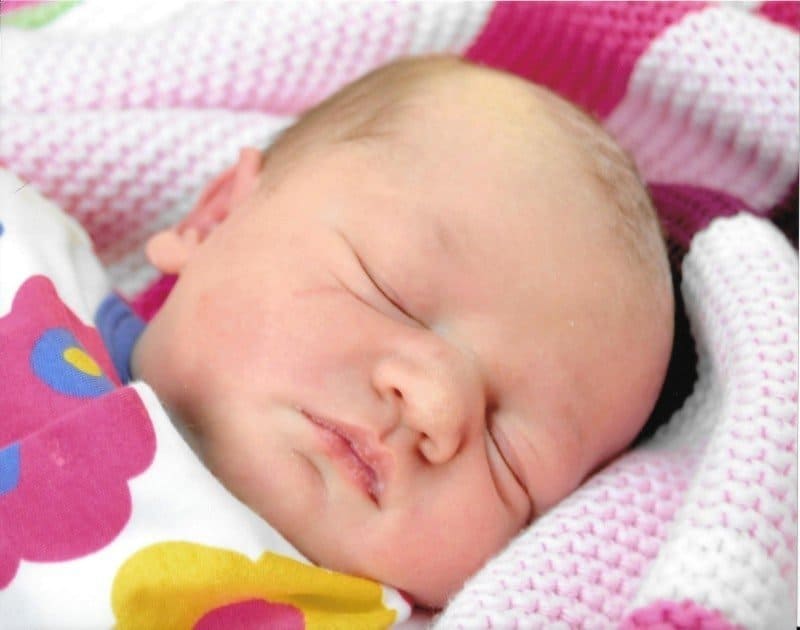 A baby lying on a bed