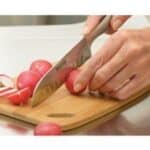 A wooden cutting board, with Santoku