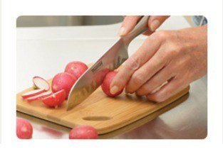 A wooden cutting board, with Santoku