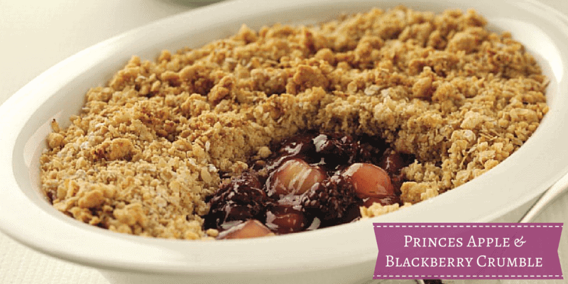 A box filled with different types of food on a plate, with Apple and Blackberry