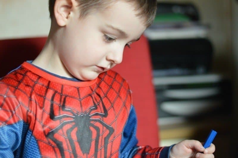 A young boy is using a phone