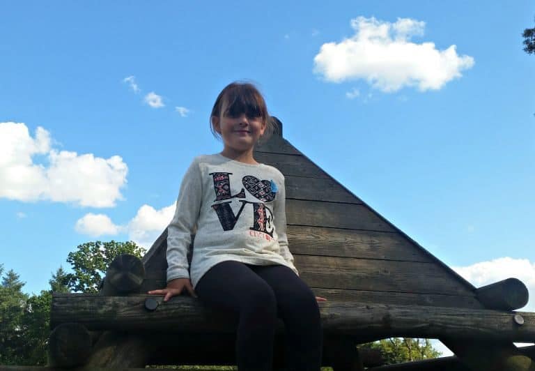 A young boy sitting on a bench