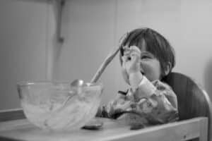 A person drinking from a bowl, with Cake and Chocolate