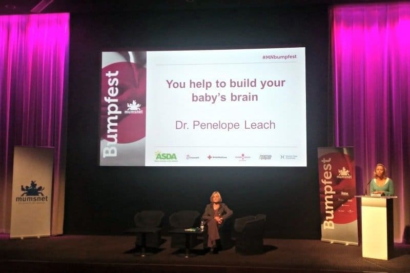 A person sitting at a desk in front of a stage