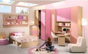 A bedroom with a pink tub and sink