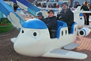 A group of people sitting around a plane