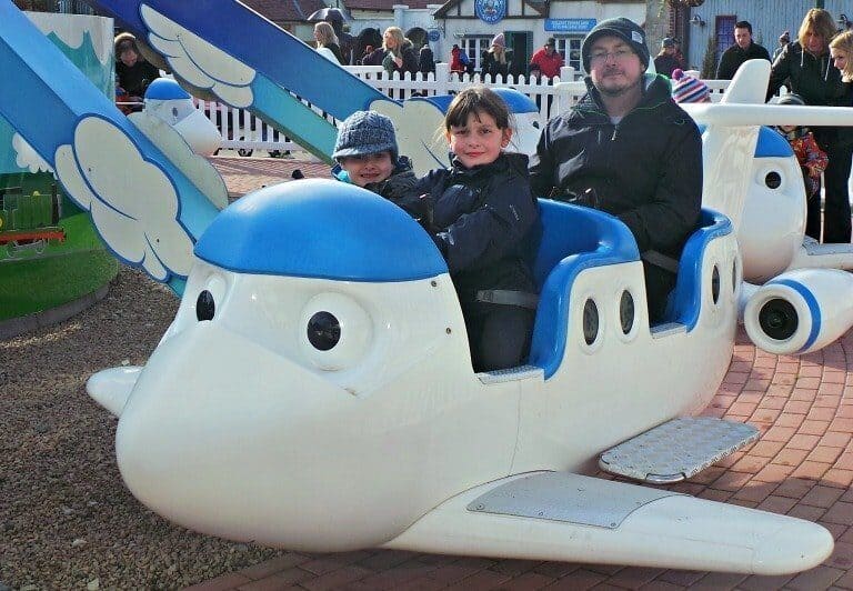 A group of people sitting around a plane