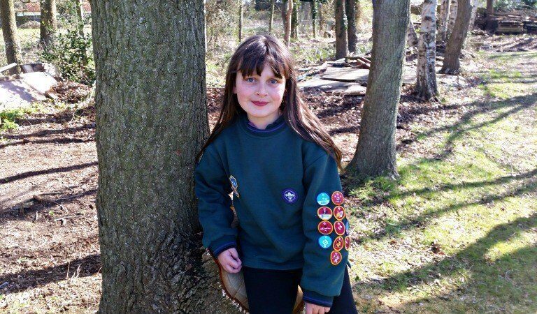 A person standing next to a tree