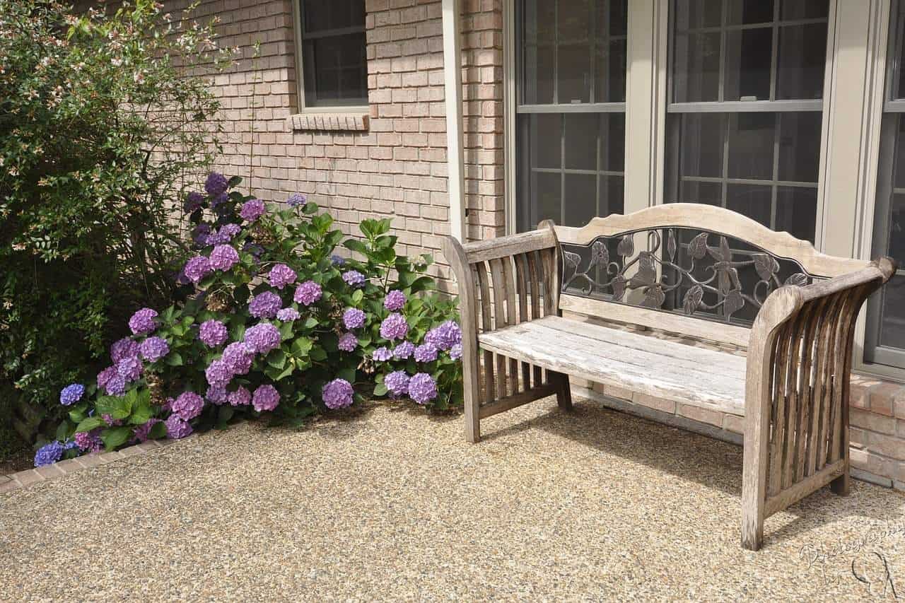 A wooden bench sitting in front of a building