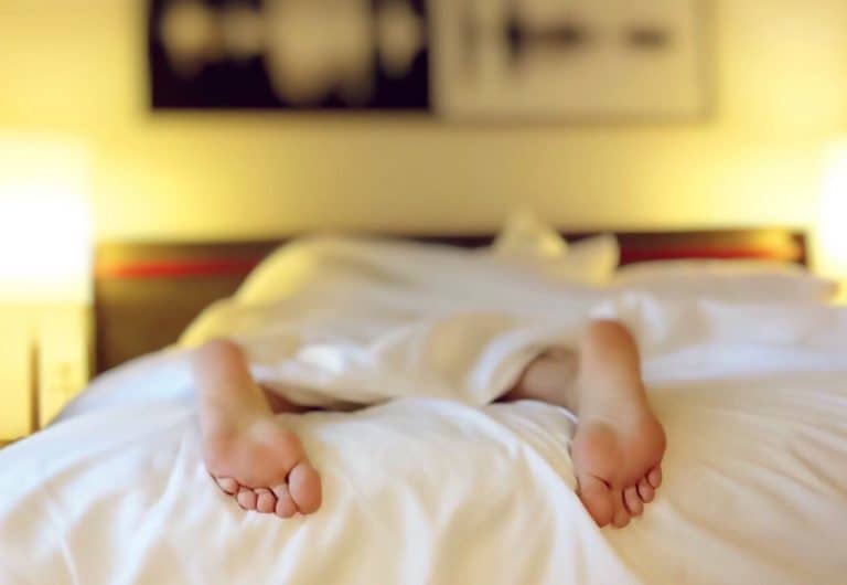 A baby lying on a bed
