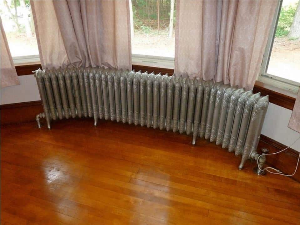 A close up of a hard wood floor next to a window