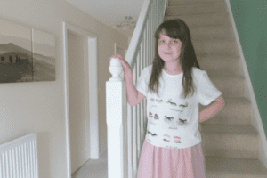 A little girl standing in a room