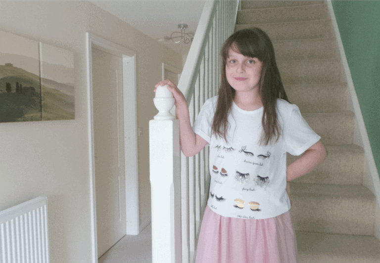 A little girl standing in a room