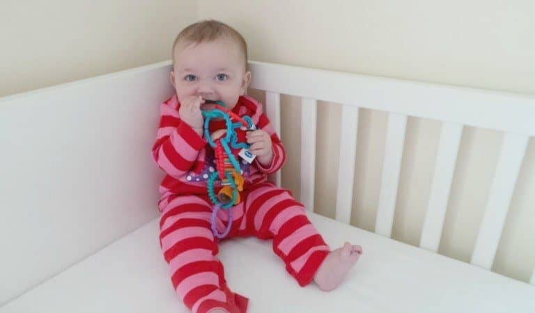 A small child sitting on a bed