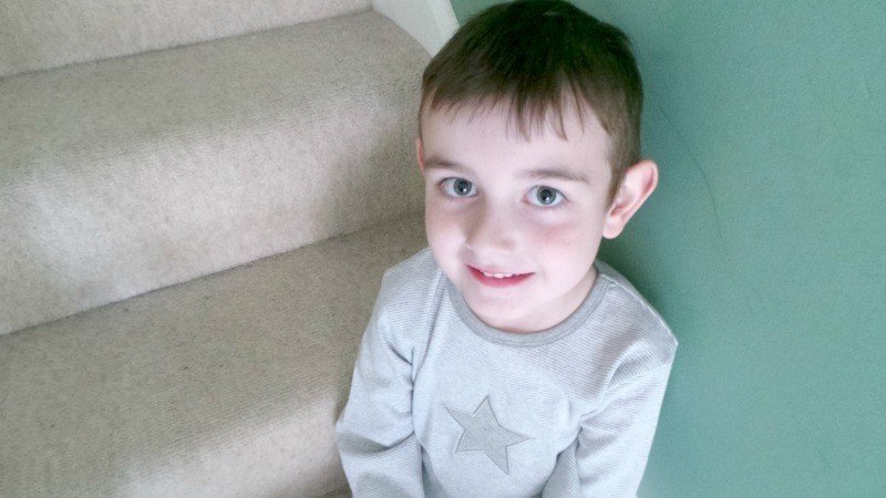 A little boy wearing a blue shirt