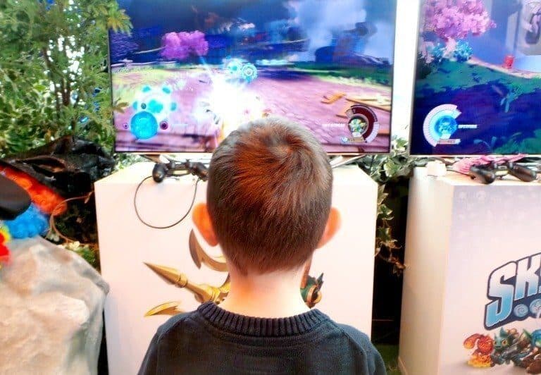 A boy standing in front of a computer