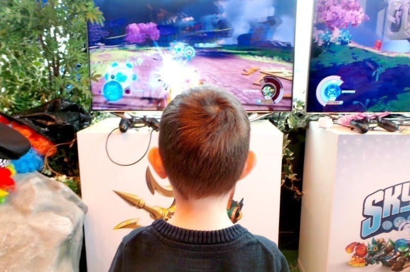 A boy standing in front of a computer