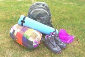 A bag of luggage sitting on top of a grass covered field