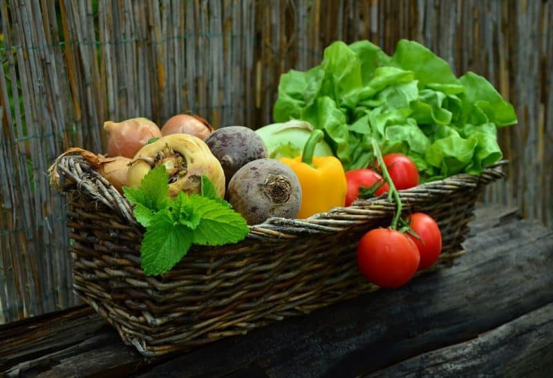 A bowl of fruit on a wooden table, with Produce and Salad