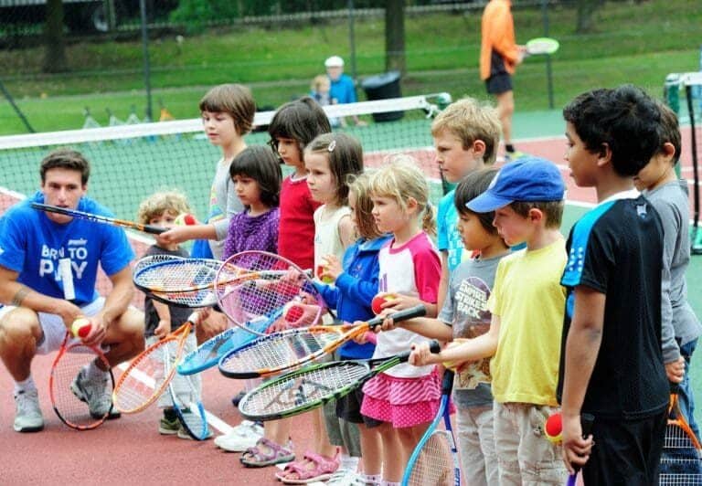 A group of people on a court with a racket