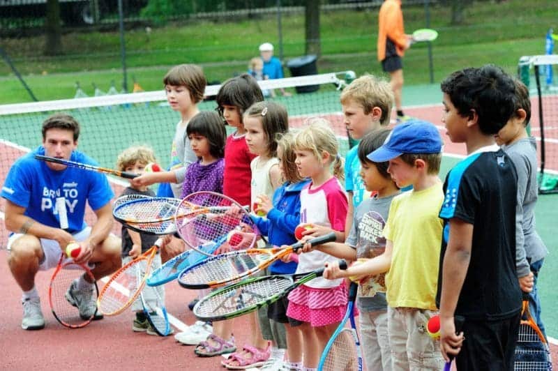 A group of people on a court with a racket