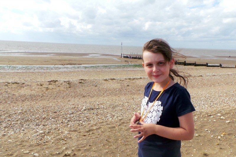 A young boy standing on a beach