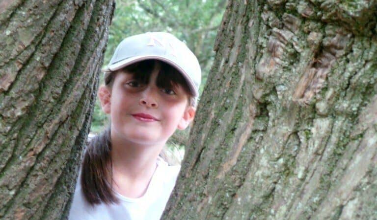 A person standing in front of a tree