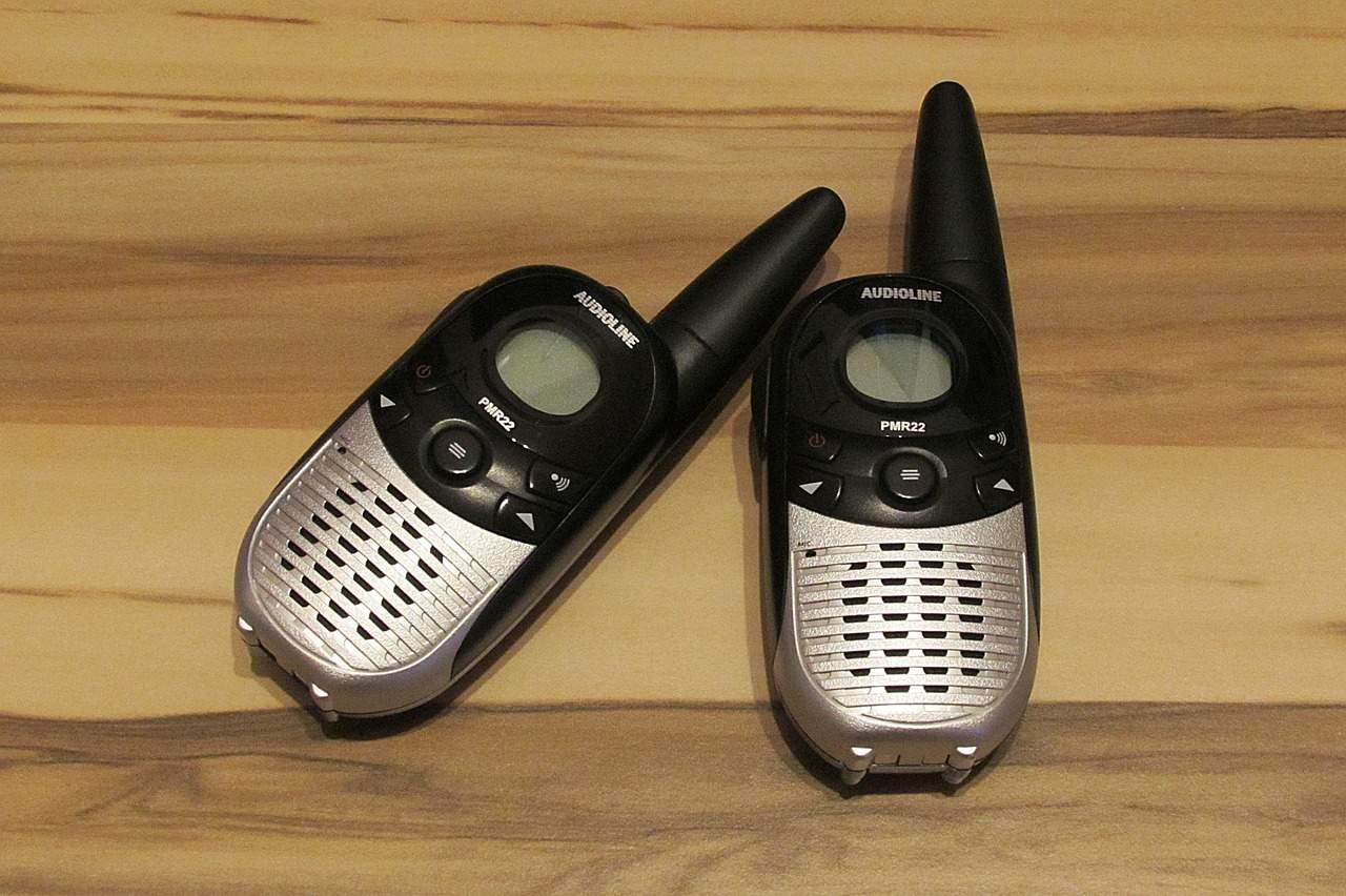 A cellphone lying on top of a wooden table