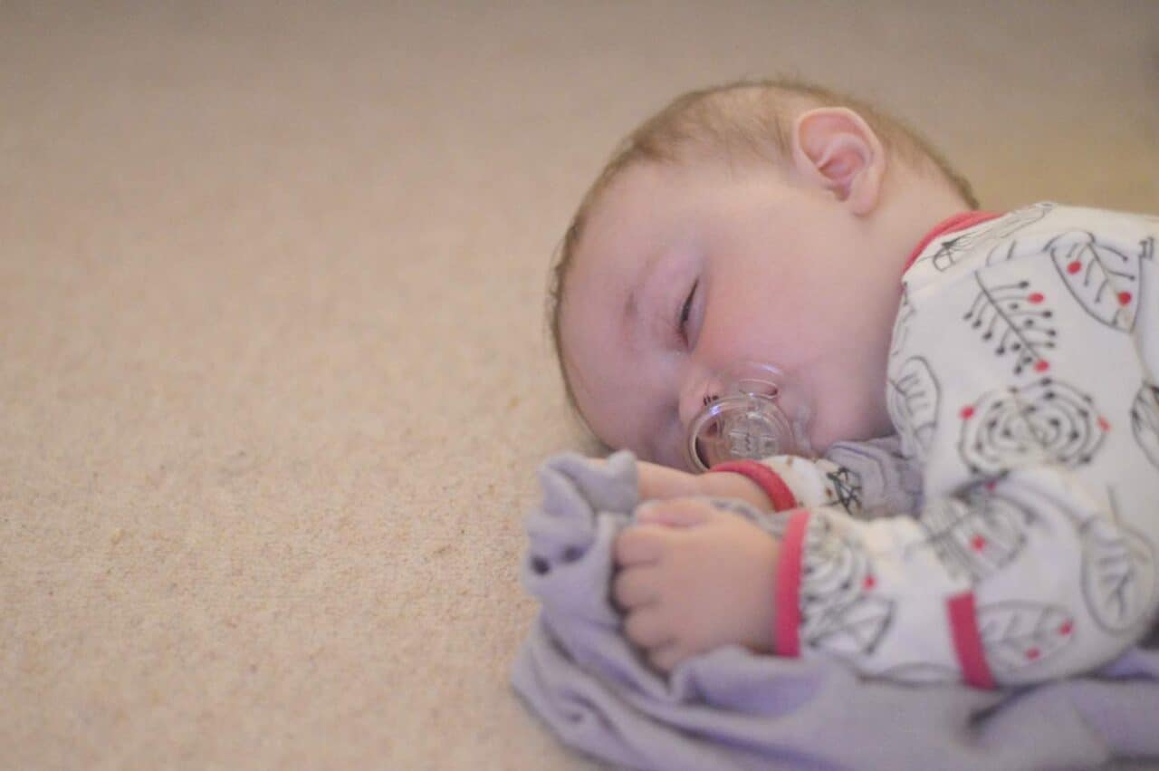 A baby lying on a bed