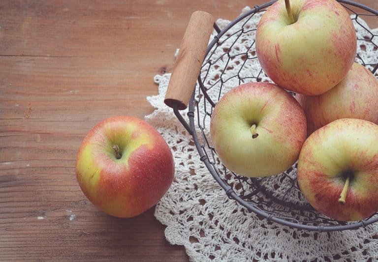 An apple sitting on top of a wooden table