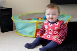 A toddler playing with a baby