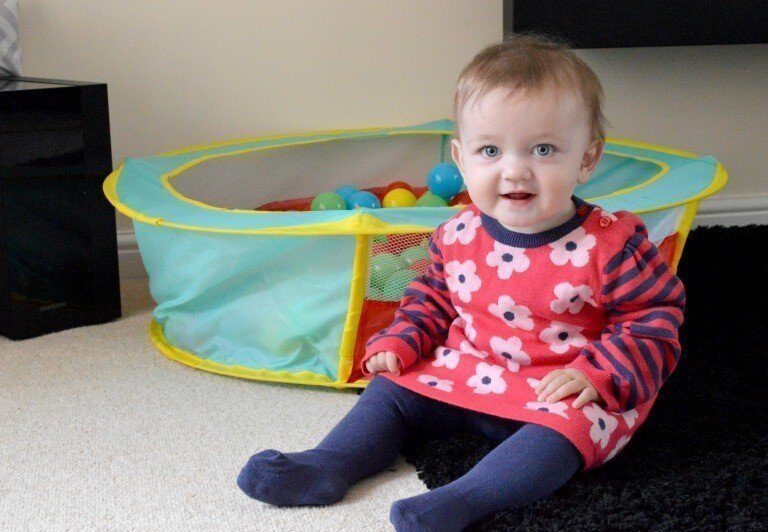 A toddler playing with a baby