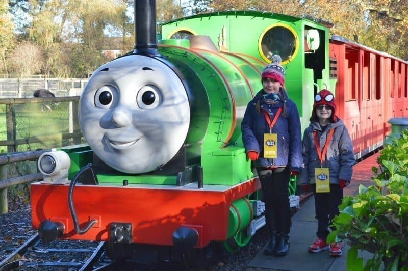 A group of people standing next to a train