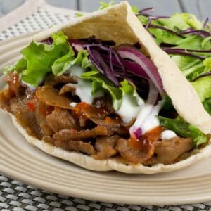 A sandwich and salad on a plate, with Kebab