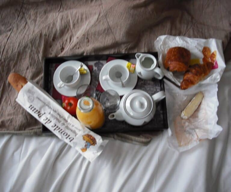 A cup of coffee sitting on top of a bed, with Upload