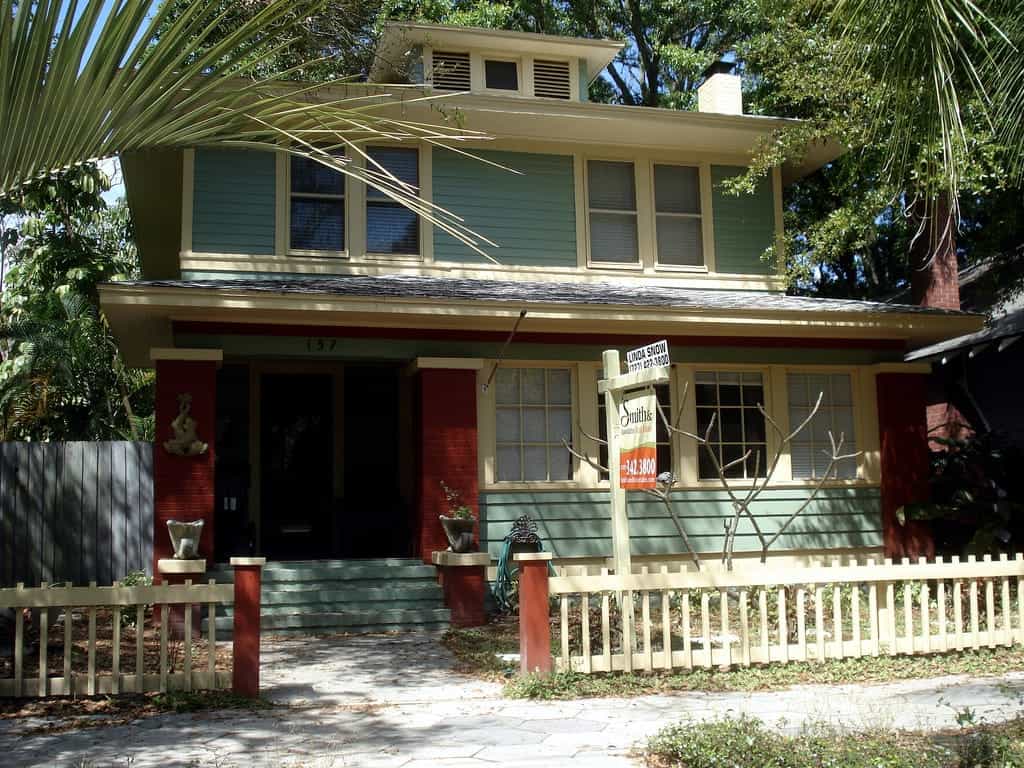 A house with a fence in front of a building