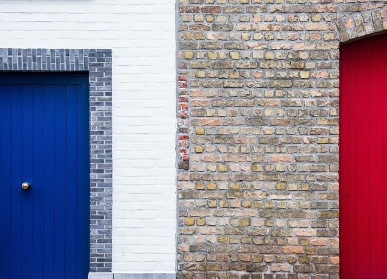 A door is open in front of a brick building