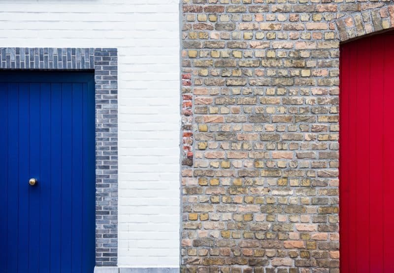 A door is open in front of a brick building