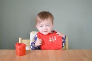 A little boy sitting on a table