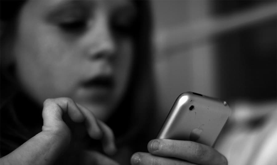 A close up of a person holding a cell phone