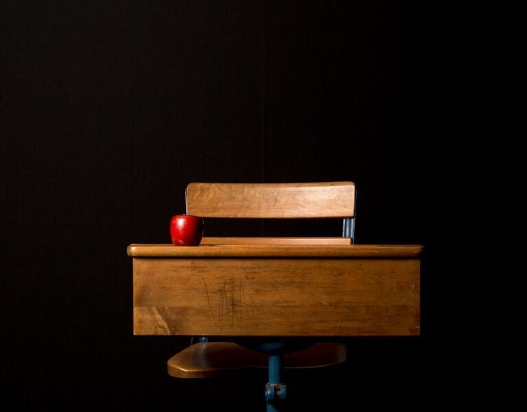 A wooden bench sitting in the dark