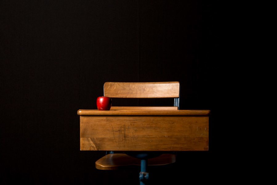 A wooden bench sitting in the dark