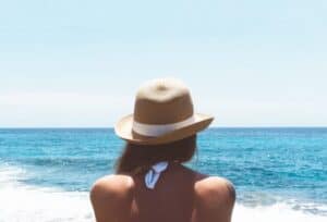 A woman standing next to a body of water