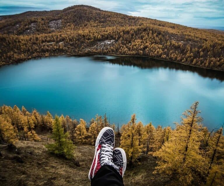 A close up of a hillside next to a body of water