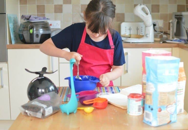 A little boy that is standing in the kitchen