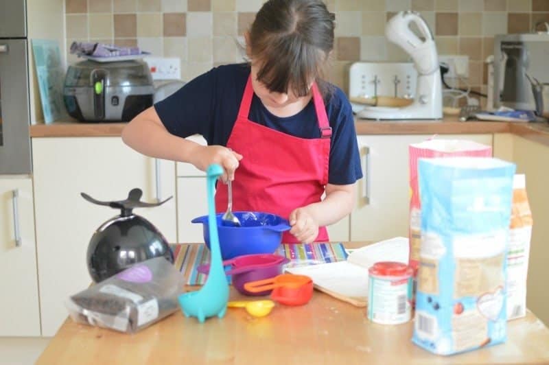 A little boy that is standing in the kitchen