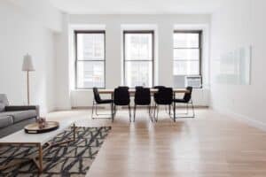 A living room filled with furniture on top of a wooden floor