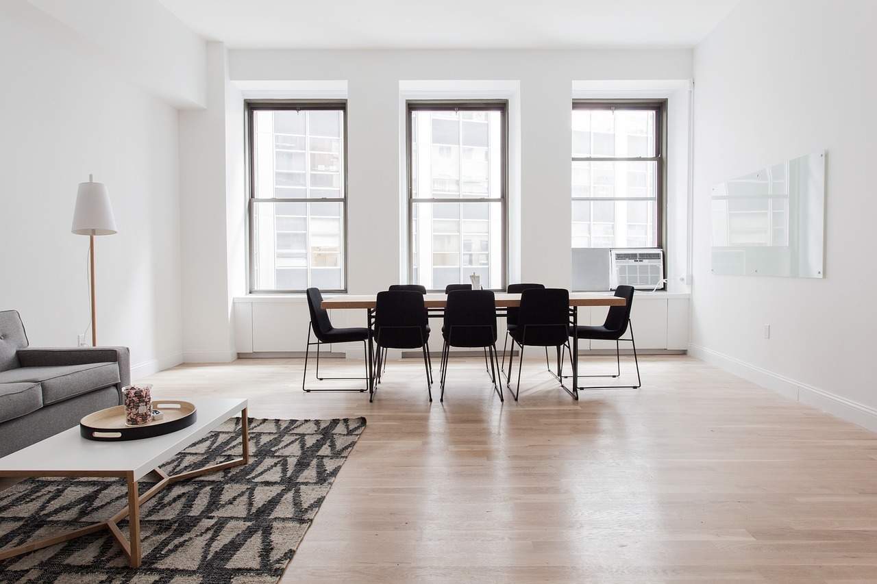 A living room filled with furniture on top of a wooden floor