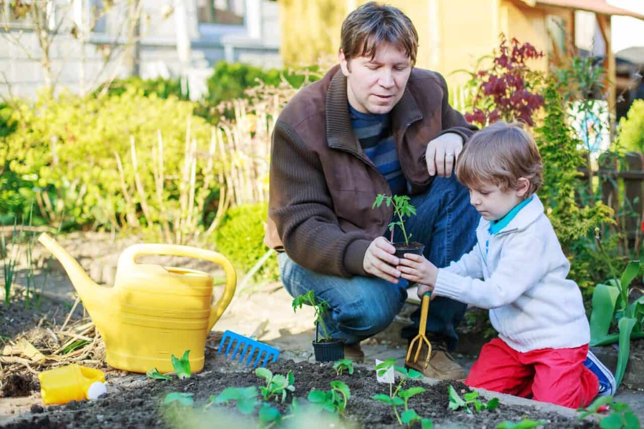 A small child is sitting in the grass