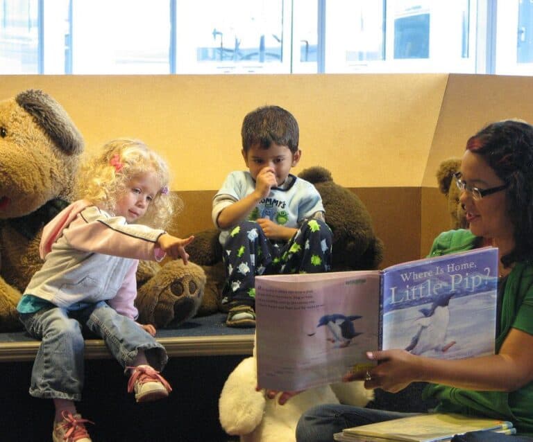 A group of stuffed animals sitting next to a man